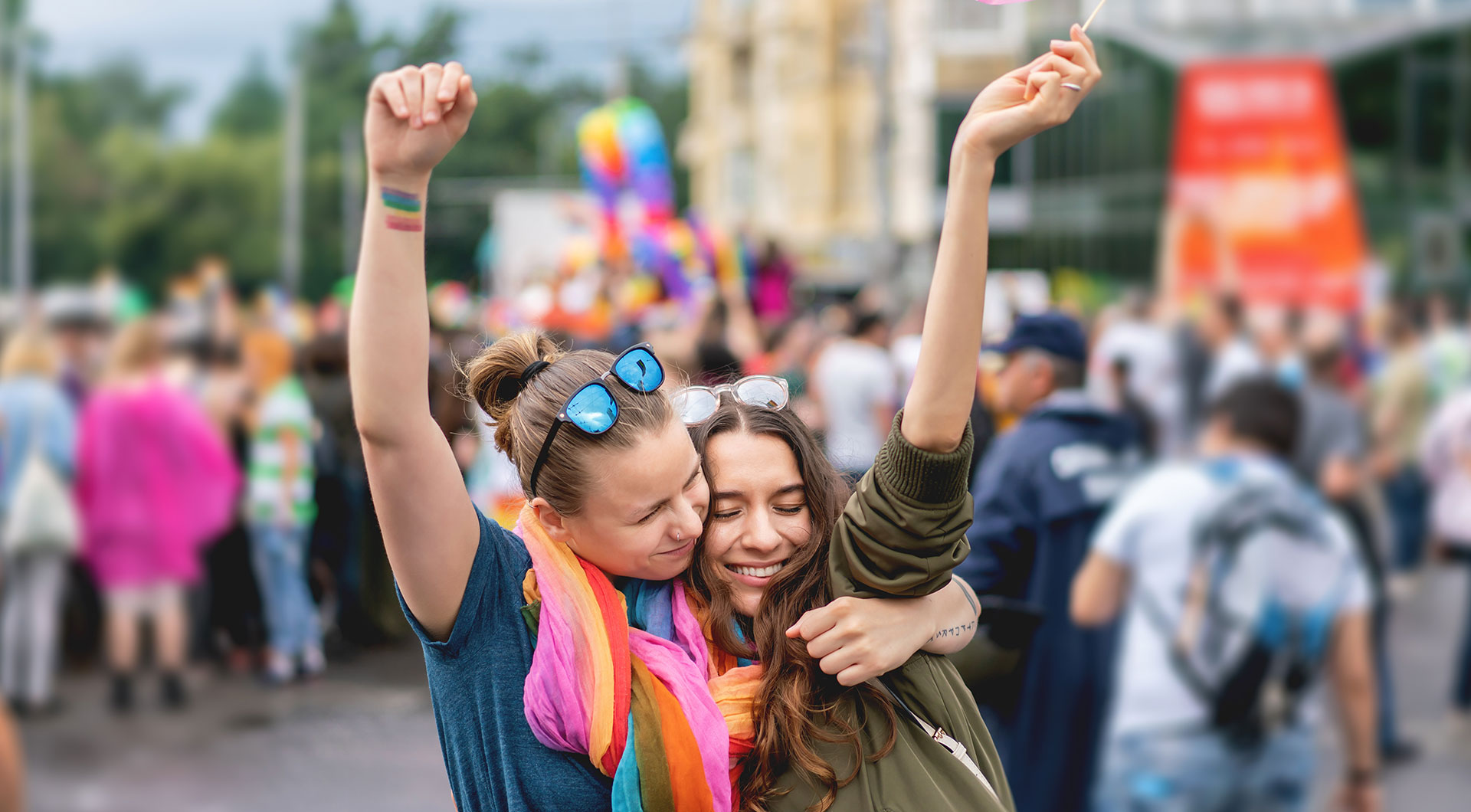 Young female couple at pride parade.